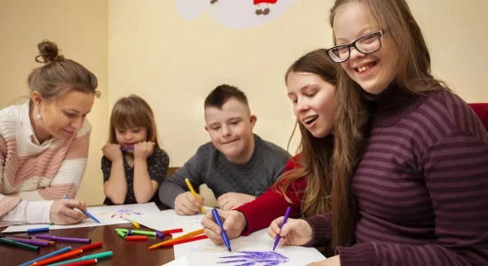 happy-girl-with-down-syndrome-posing-while-drawing